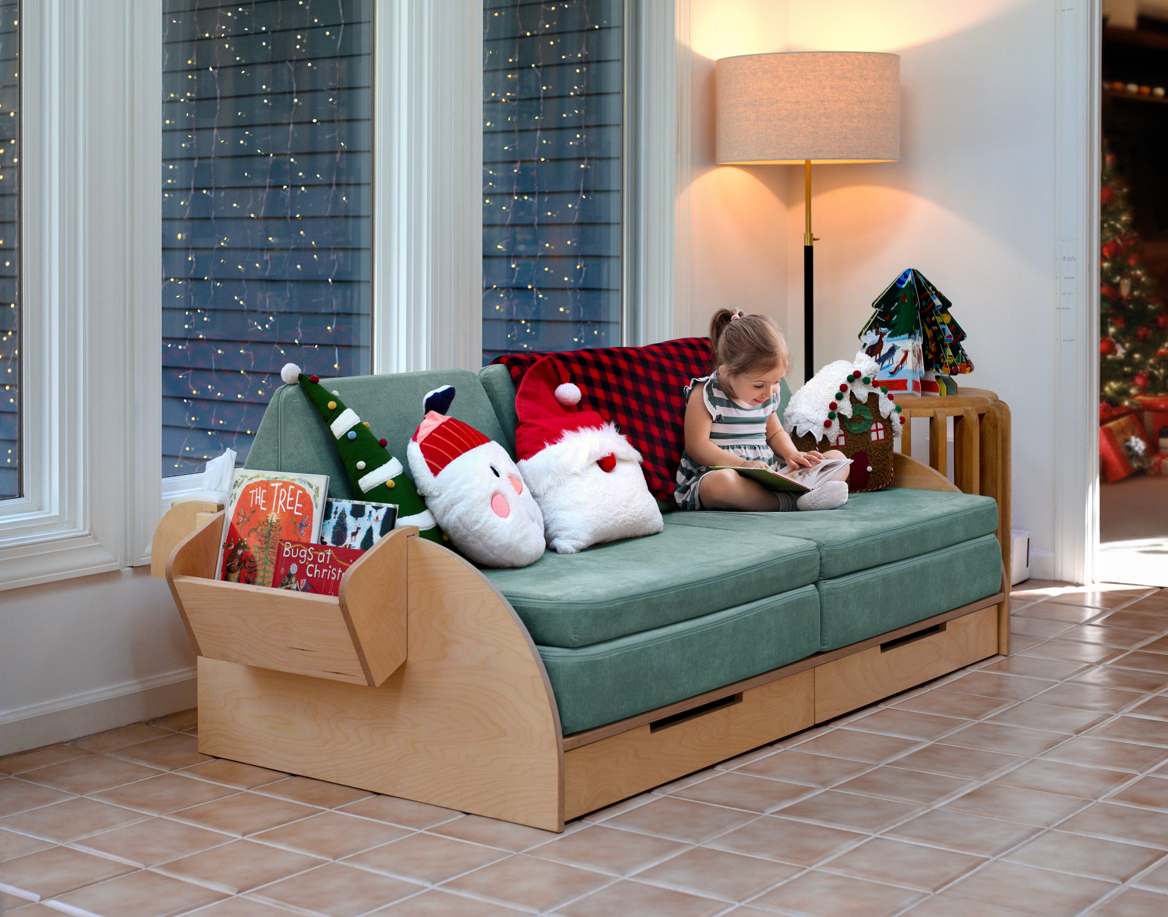 A little girl reading on the Frame for the Play Couch.